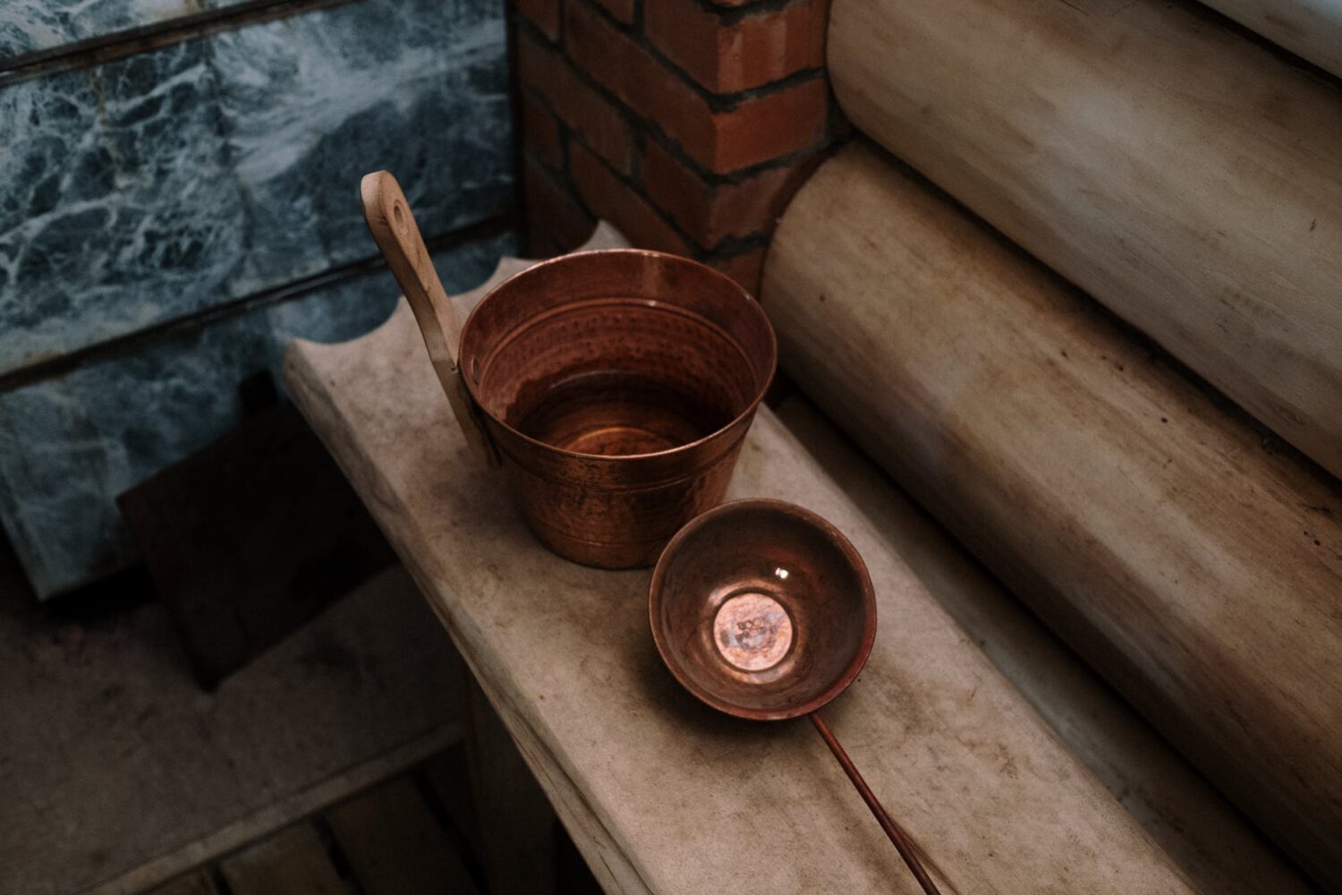 brown wooden ladle in brown round plastic bucket